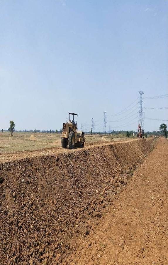 Dozer grading a canal embankment