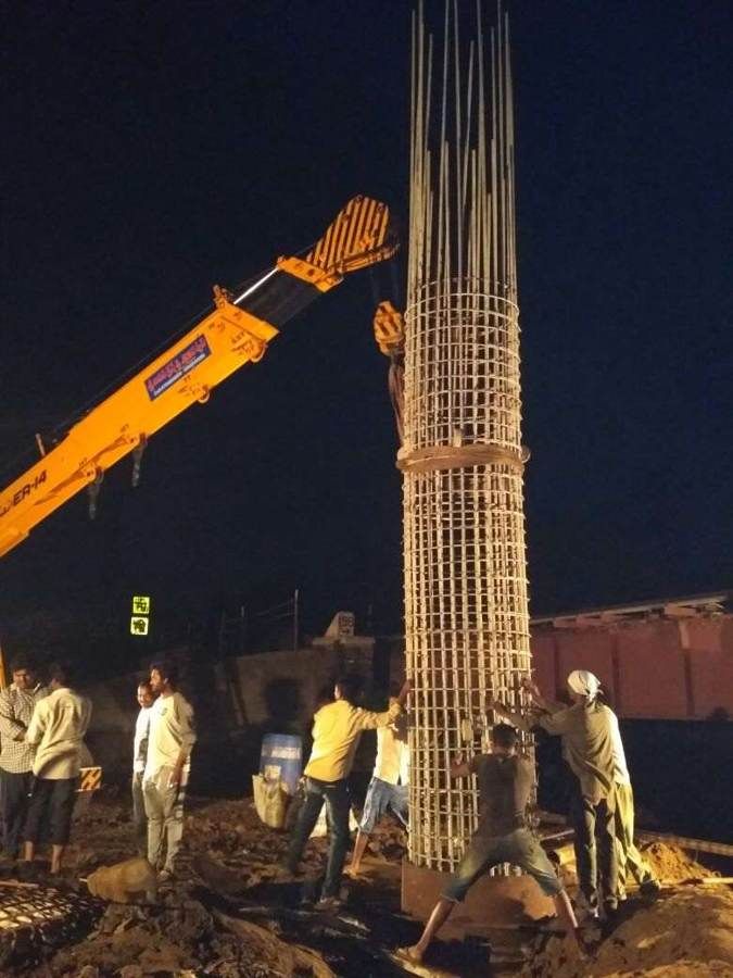 Pile cage being lowered at night